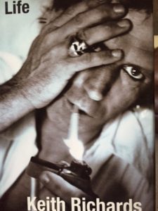 book cover features an extreme close up of Richards lighting a cigarette