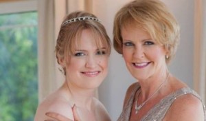 Mother and daughter pose, smiling and radiant, on Lauren's wedding day