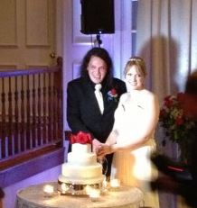 Lauren and Phil pose with their wedding cake