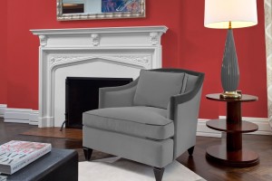 Dulux photo of red walls with a white fireplace and a rich grey chair on a white rug
