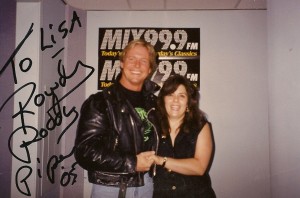 Wrestler Piper and me in front of the MIX 999 logo. The photo is autographed