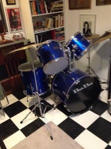 Blue drum kit on black and white checked floor