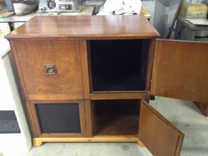 outdated looking solid wood cabinet with four doors in a cube form