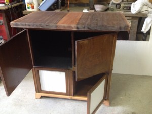counter piece on top of cabinet is dark wood with a light strip on the middle. The bottom doors are now white