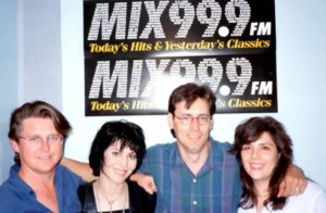 JJ Johnston, Joan Jett, Wayne Webster and me, all arm in arm in front of a MIX 999 poster