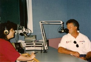 Mario Andretti and I across from each other in a recording studio, each at a microphone