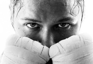 close-up of Ronda with her gloved hands up as if she's ready to fight