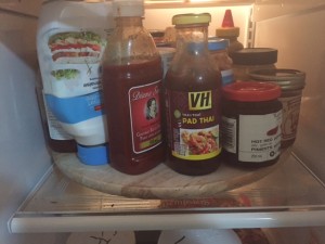 wooden lazy susan takes up the whole fridge shelf and is loaded with jars of sauces, mayo, salsa etc.
