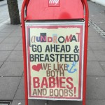Sign reads: Go ahead and breastfeed. We like both babies and boobs!