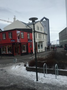typical corner with ice on the sidewalk and a view of the harbour and mountains in the background