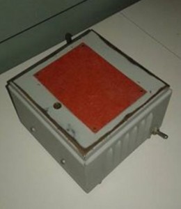 metal cube with a copper-looking layer on top and a simple switch on the side