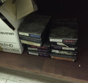 stack of carts with ancient labels on them, made by a label-maker, in red, blue and white