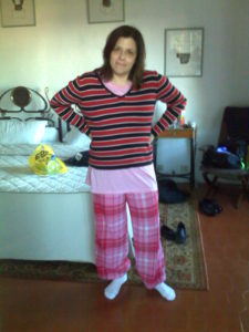I'm posing for the camera wearing pyjamas, a sweater and thick socks, all in clashing colours