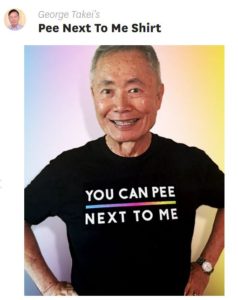 George Takei wearing a black T that reads YOU CAN PEE NEXT TO ME