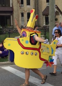 man dances down the street while dressed as a yellow submarine to promote this fall's Beatles Festival in London