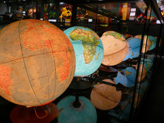 a collection of lit globes of the world