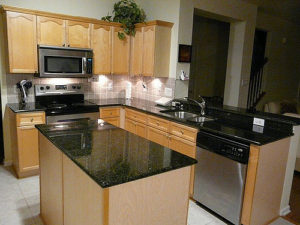 oak kitchen with black granite countertops