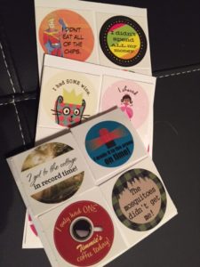 pages of round stickers, about the size of a toonie, with various sayings