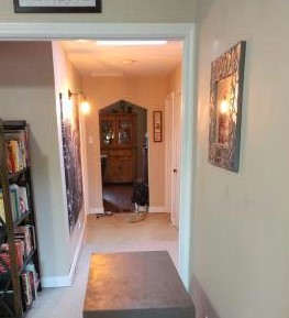long view of the hallway with carpet down it