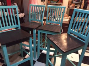 four stools with chocolate brown seats and sky blue legs