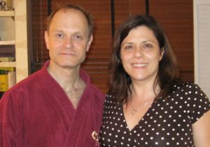 David Hyde Pierce wearing a burgundy bathrobe and me in a dress, brown with white polka-dots