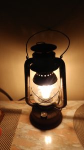 railroad lantern with an Edison bulb inside, lit up