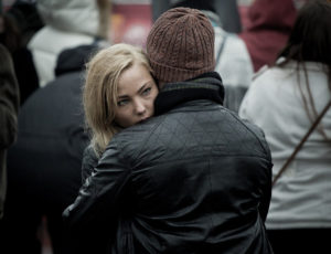 a sad woman gets a hug from a friend