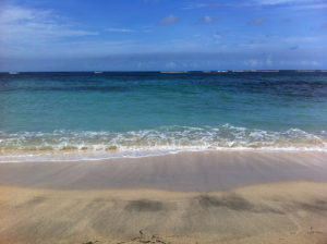 sandy beach with calm blue water