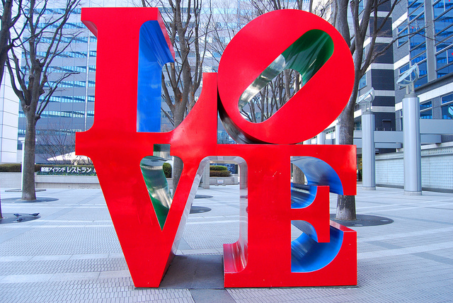 Huge red letters spelling LOVE on a city street