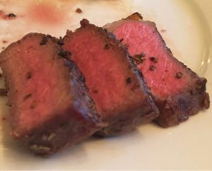 closeup of three perfect slices of steak