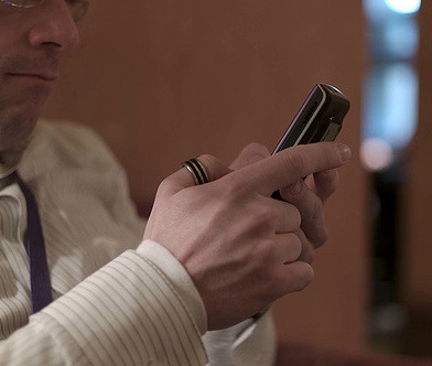 man texting on a smartphone