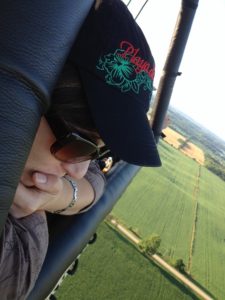 close-up of me looking over the edge of the balloon with farmer's fields far off in the background