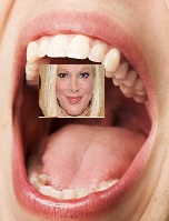 open mouth with tiny head-shot of actress Tori Spelling on the roof of it