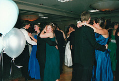 bunch of dressed up kids dancing at their prom