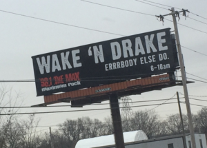 Billboard for Wake N Drake, a morning show on a rock station that airs 6-10 am. The slogan is "Errrbody else do." That's not a typo.