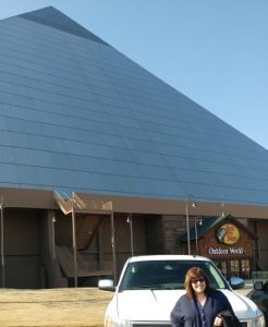 Me in front of our white pick-up with the shiny Bass Pro pyramid buidling in the background