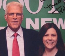 me posing beside Ted Danson at 680 News. You can see part of his autograph on the photo