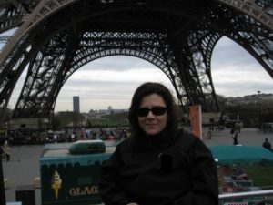 me in the foreground with the base of the Eiffel tower behind me
