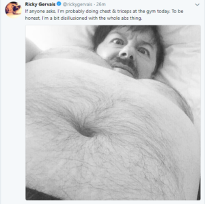 selfie taken with his belly in the foreground. The tweet suggests he's given up on working on his abs in the gym