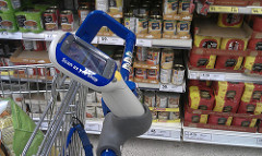 scan as you shop gizmo attached to the handle of a shopping cart