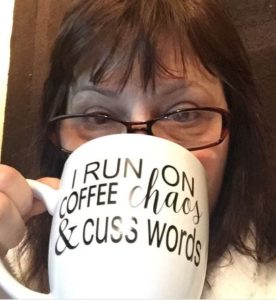 Drinking from my new mug that reads: I run on coffee, chaos and cuss words!
