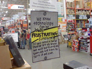 photo of hand-written sign at a Home Depot reads: We know technology can be frustrating sometimes. If you need a hand please let us know. We will be there as soon as we can to sort it all out.