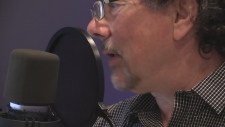 screen clip of Derek speaking into a windscreened mic