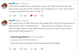 Pink's exchange with a women on twitter who says she looks old. She tells the woman that she earned every one of her laugh lines and that wrinkles tell the world that she has lived.