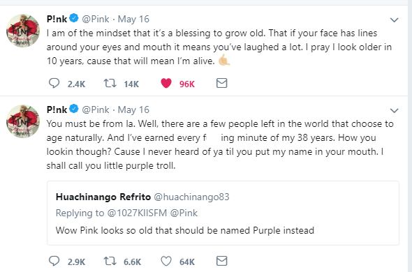 Pink's exchange with a women on twitter who says she looks old. She tells the woman that she earned every one of her laugh lines and that wrinkles tell the world that she has lived. 