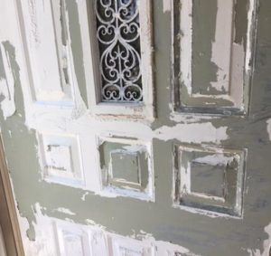 green metal showing through under white paint