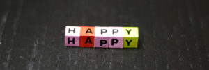 happy spelled out in wooden blocks