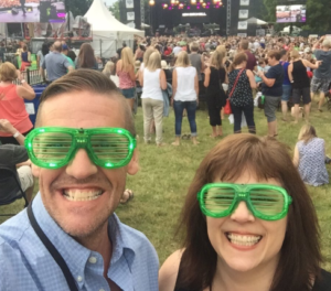 Me and Ken with a crowd and Kim Mitchell on stage in the background. We are wearing green plastic glasses with blinking green lights on them