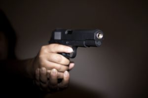 hands holding a gun to fire it