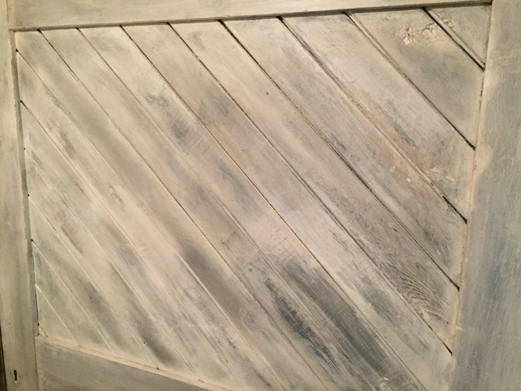 closeup of the distressed, white boards in the headboard